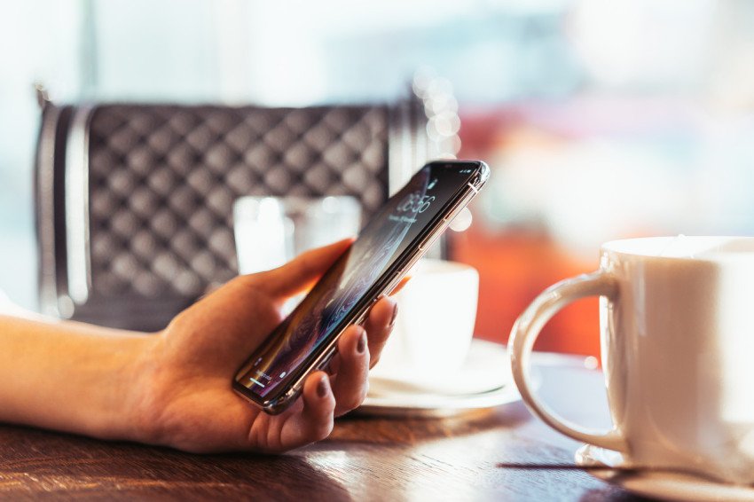 Woman holding modern smartphone in hand