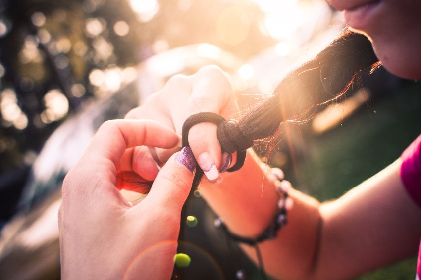 Girls braid in sunset