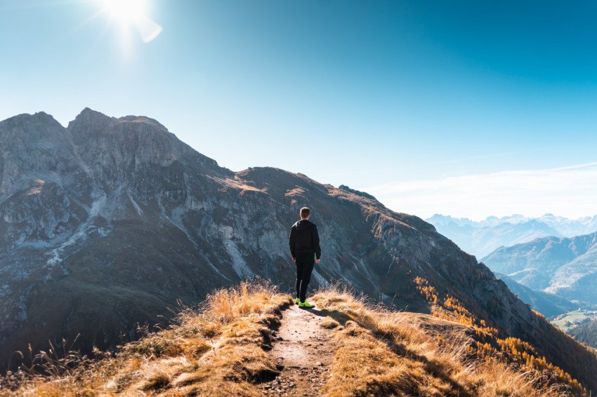 Young man climbed the mountain top free photo